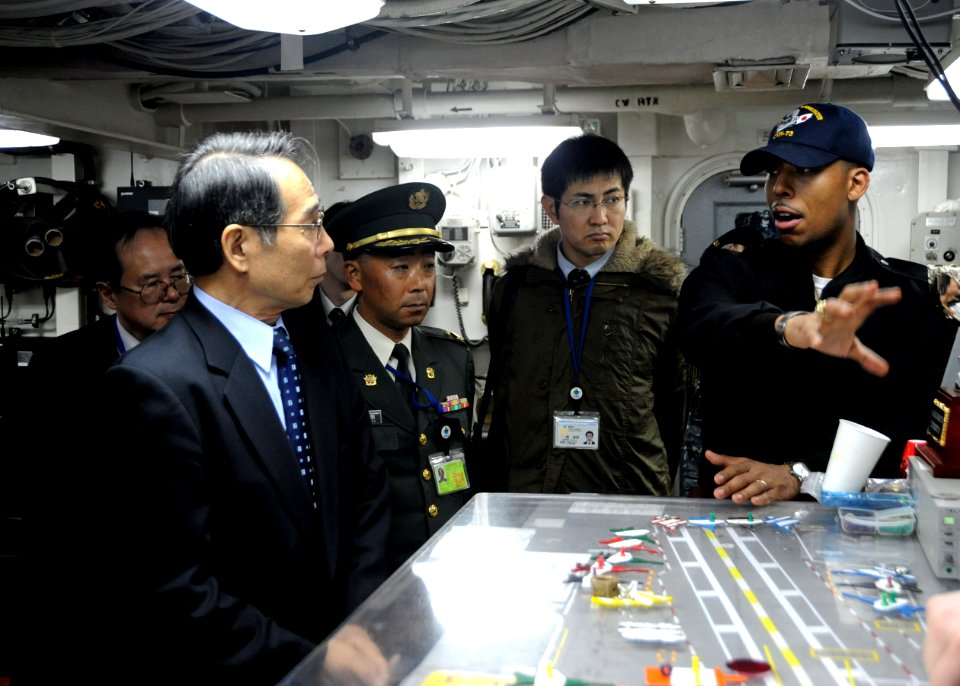 Flickr - Official U.S. Navy Imagery - A Sailor gives a tour of flight deck control to Inspector General of the Inspector General of the Japanese Ministry of Defense.
