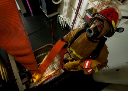 Flickr - Official U.S. Navy Imagery - A Sailor guides a hose down a ladderwell.