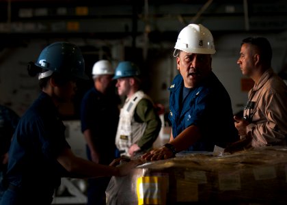 Flickr - Official U.S. Navy Imagery - A Sailor guides and instructs Sailors and Marines in the hangar bay.