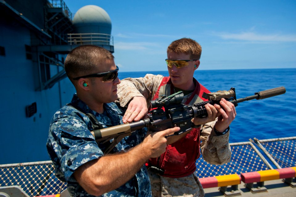 Flickr - Official U.S. Navy Imagery - A Marine how to properly handle an M4 rifle.