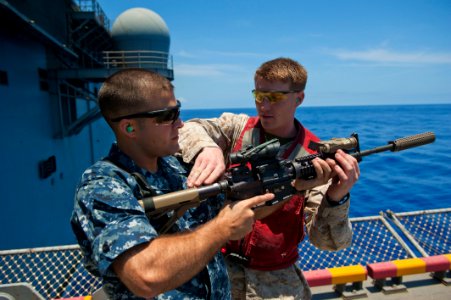 Flickr - Official U.S. Navy Imagery - A Marine how to properly handle an M4 rifle.