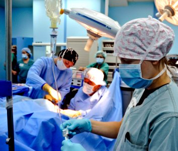 Flickr - Official U.S. Navy Imagery - A Navy officer gives an Indonesian women pain medications during surgery.