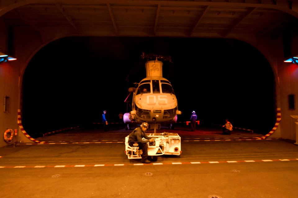 Flickr - Official U.S. Navy Imagery - A Sailor maneuvers a helicopter aboard USS Makin Island.