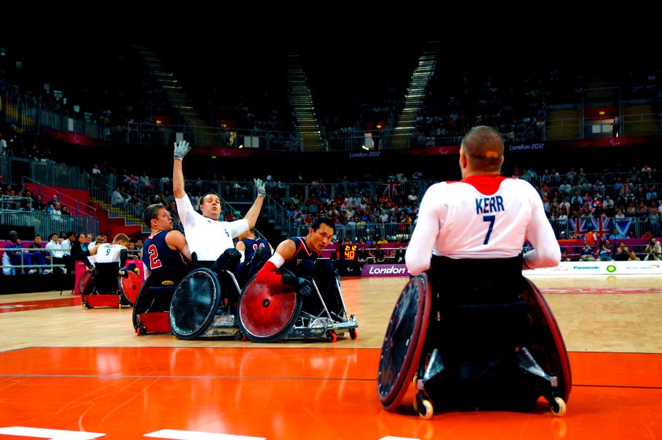Flickr - Official U.S. Navy Imagery - A Navy veteran and a team captain for the 2012 U.S. Paralympic Rugby Team, defends a Team Great Britain player.