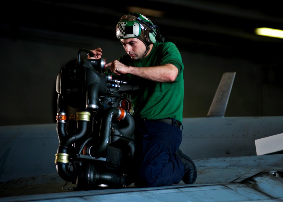 Flickr - Official U.S. Navy Imagery - A Sailor perform maintenance on a jet.
