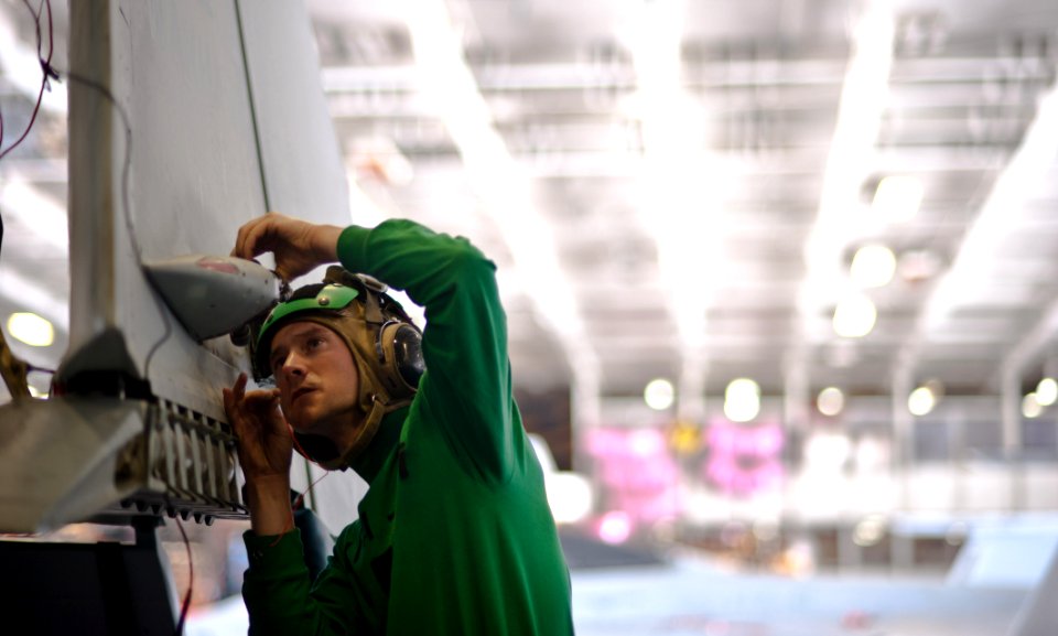 Flickr - Official U.S. Navy Imagery - A Sailor performs maintenance on a jet.