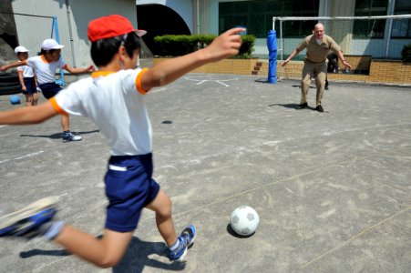 Flickr - Official U.S. Navy Imagery - A Sailor prepares to block a goal from a student at Ogamo Elementary School.