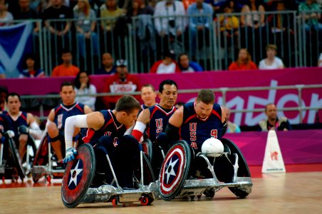 Flickr - Official U.S. Navy Imagery - A Navy veteran and a team captain for the 2012 U.S. Paralympic Rugby Team, trails two teammates as they go through warm-up drills.