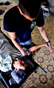 Flickr - Official U.S. Navy Imagery - A physical therapist shows a Vietnamese man how to do therapeutic stretches.
