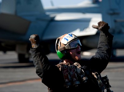 Flickr - Official U.S. Navy Imagery - A Sailor celebrates another launch as a jet departs the flight deck.