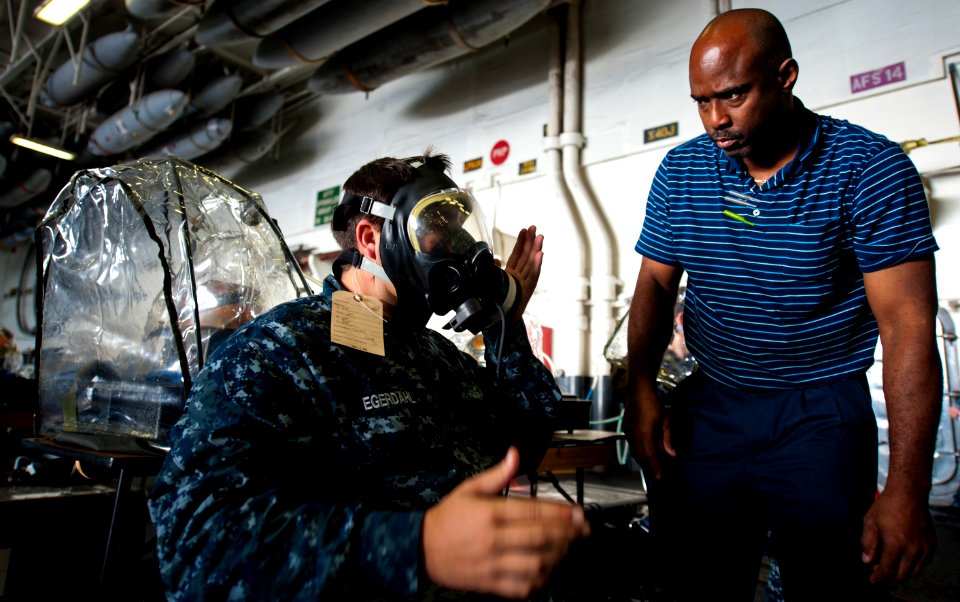 Flickr - Official U.S. Navy Imagery - A Sailor checks the seal of his gas mask.