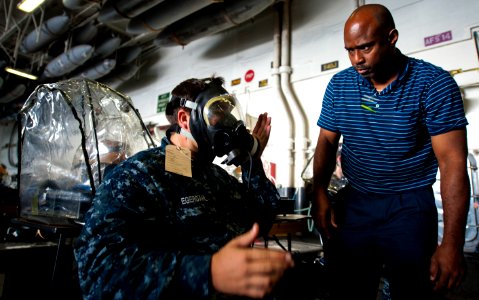 Flickr - Official U.S. Navy Imagery - A Sailor checks the seal of his gas mask.
