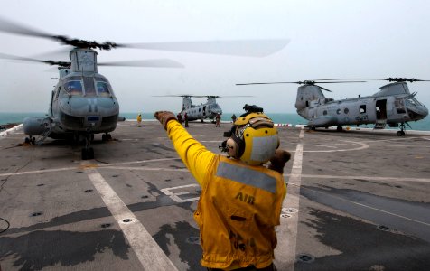 Flickr - Official U.S. Navy Imagery - A Sailor signals a helicopter to turn off its engine on the flight deck.