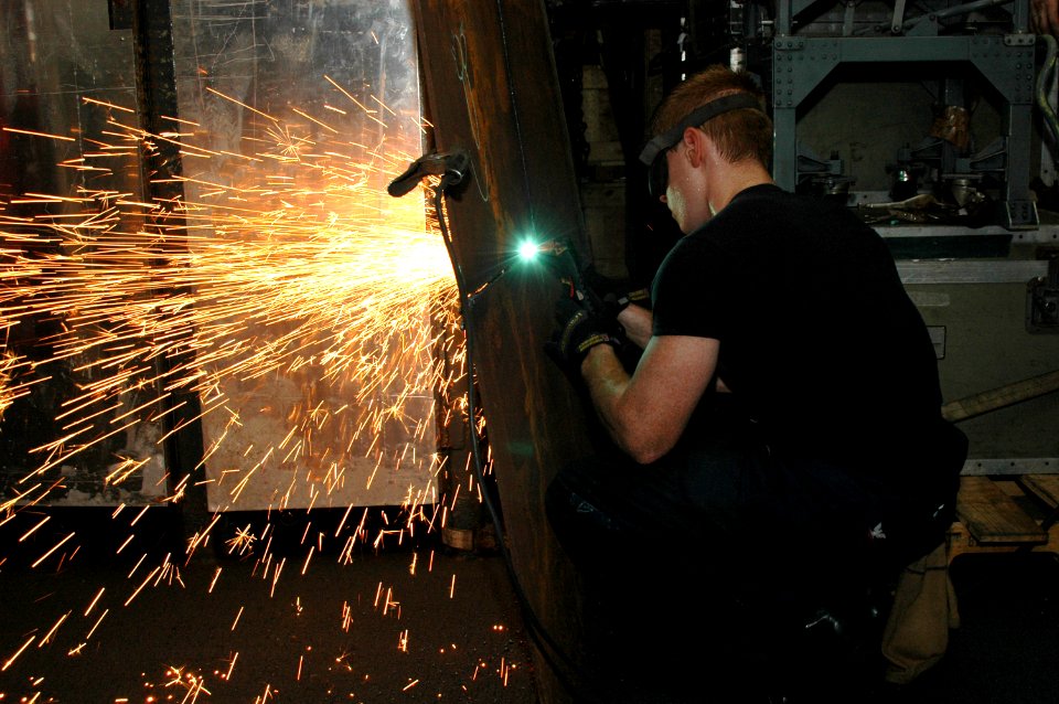 Flickr - Official U.S. Navy Imagery - A Sailor cuts a piece of metal.
