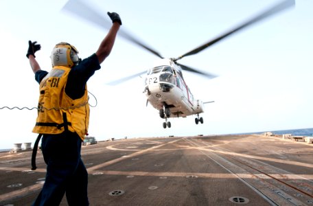 Flickr - Official U.S. Navy Imagery - A Sailor directs a helicopter. (2)