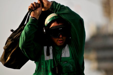 Flickr - Official U.S. Navy Imagery - A Sailor carries tools on the flight deck.