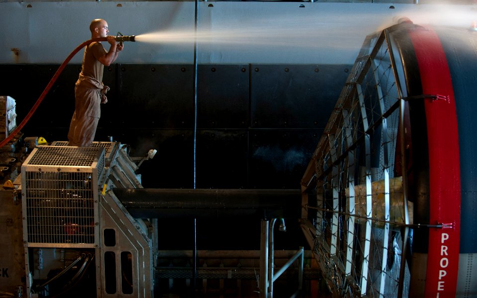 Flickr - Official U.S. Navy Imagery - A Sailor cleans the propeller of a landing craft air cushion.