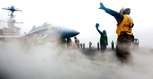 Flickr - Official U.S. Navy Imagery - A Sailor directs an F-A-18 Hornet.