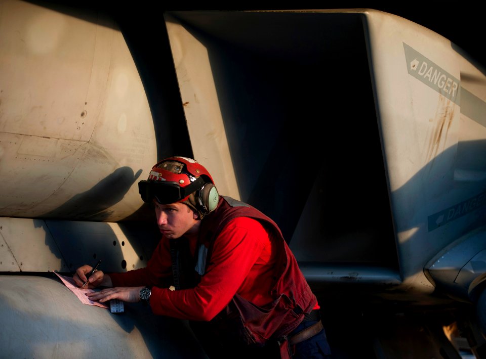 Flickr - Official U.S. Navy Imagery - A Sailor fills out ordnance load-out forms for an F-A-18F Super Hornet.