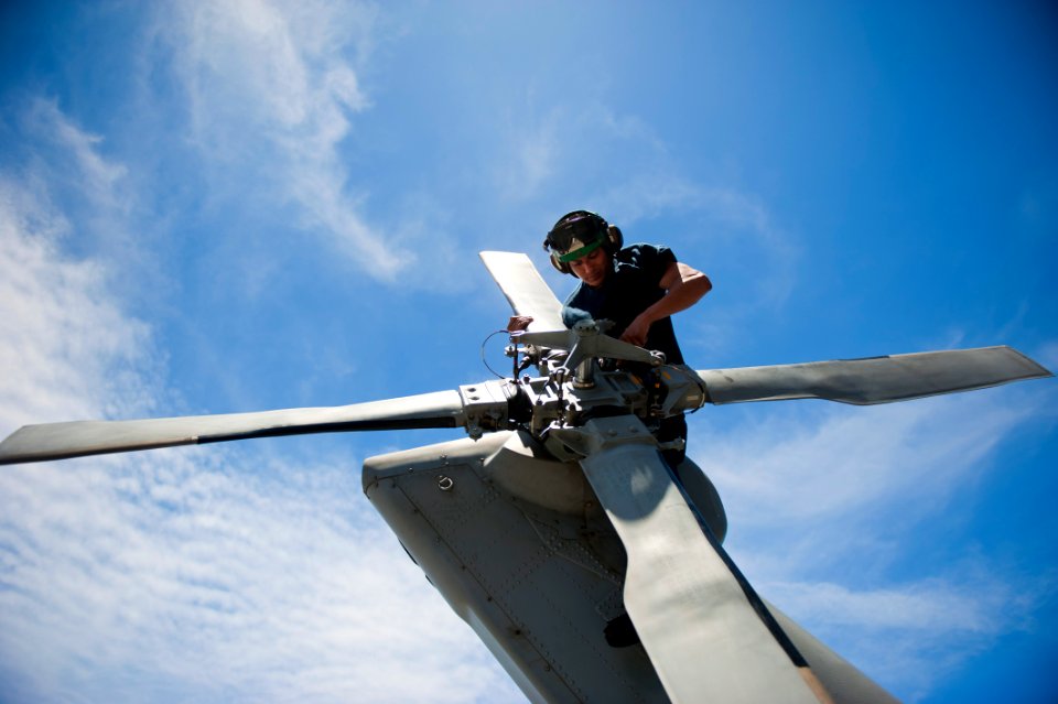 Flickr - Official U.S. Navy Imagery - A Sailor conducts maintenance on the propeller of a helicopter.