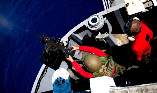 Flickr - Official U.S. Navy Imagery - A Sailor fires a .50-caliber machine gun during a live-fire exercise aboard the Nimitz-class aircraft carrier USS John C. Stennis.
