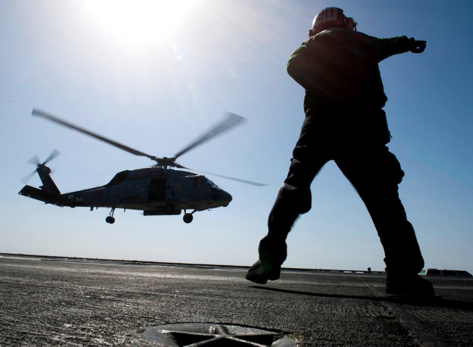 Flickr - Official U.S. Navy Imagery - A Sailor directs the launch of a helicopter.