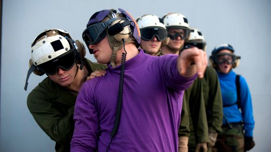 Flickr - Official U.S. Navy Imagery - A Sailor directs a Marine on the flight deck.