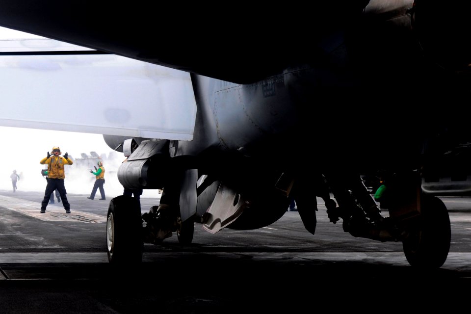Flickr - Official U.S. Navy Imagery - A Sailor directs an aircraft toward a catapult.