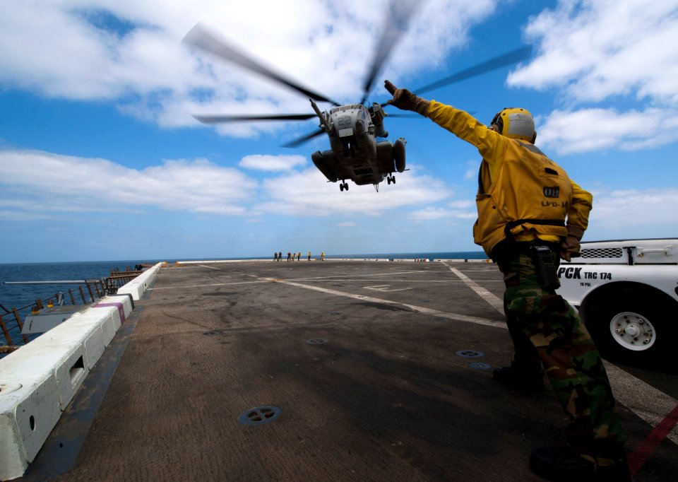 Flickr - Official U.S. Navy Imagery - A Sailor guides a helicopter on to the flight deck.