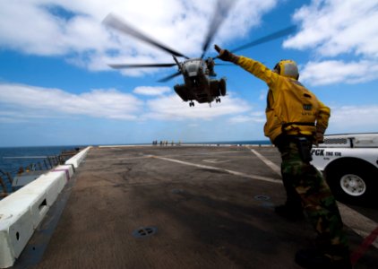Flickr - Official U.S. Navy Imagery - A Sailor guides a helicopter on to the flight deck.