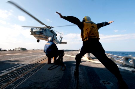 Flickr - Official U.S. Navy Imagery - A Sailor guides an SH-60B at sea.