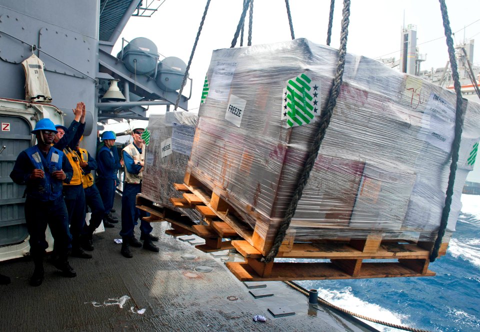 Flickr - Official U.S. Navy Imagery - A Sailor guides in a pallet of supplies during a replenishment at sea.