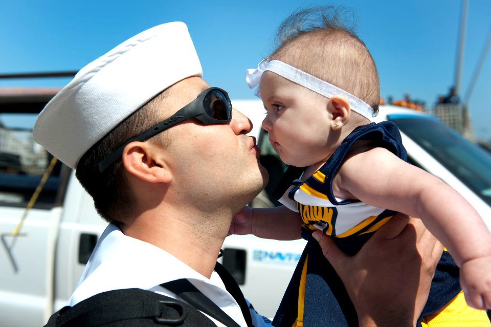Flickr - Official U.S. Navy Imagery - A Sailor greets his newborn child after returning.