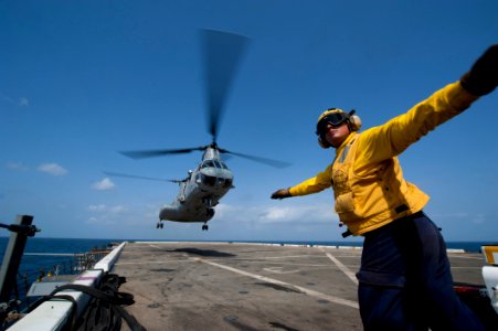 Flickr - Official U.S. Navy Imagery - A Sailor guides a helicopter on to the flight deck. (1)