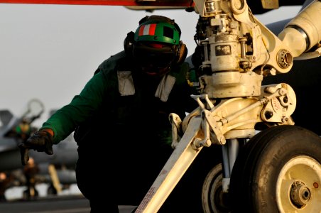 Flickr - Official U.S. Navy Imagery - A Sailor guides an aircraft into place for launch. photo