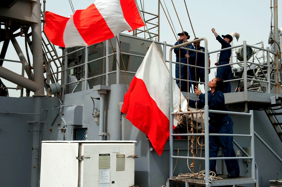 Flickr - Official U.S. Navy Imagery - A Sailor lowers signal flags.