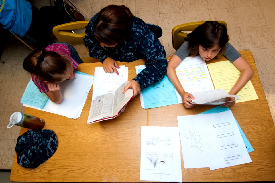 Flickr - Official U.S. Navy Imagery - A Sailor helps students with their class work during a community relations project.