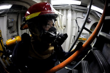 Flickr - Official U.S. Navy Imagery - A Sailor passes a fire hose to Sailors fighting a simulated fire during a damage control drill.