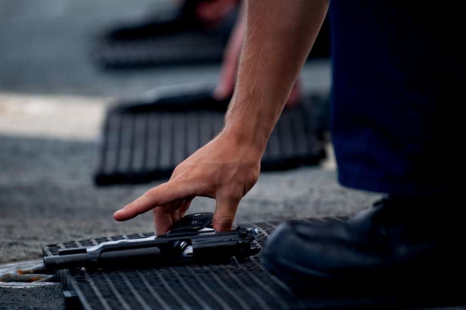 Flickr - Official U.S. Navy Imagery - A Sailor picks up an M9 pistol.