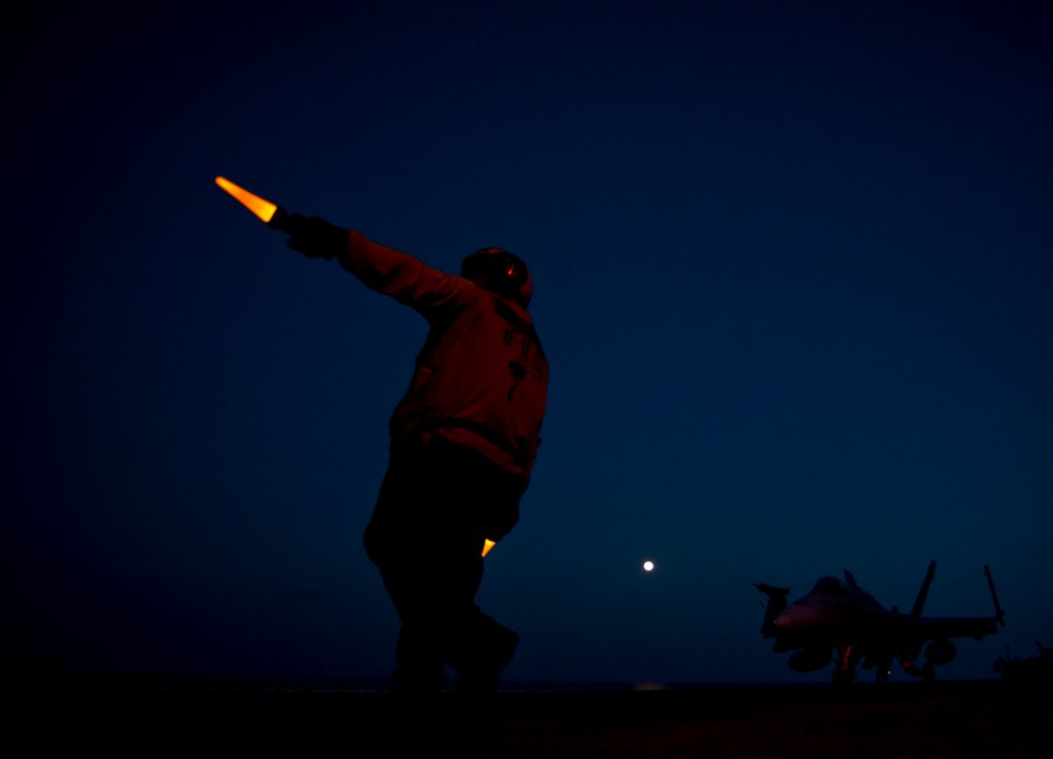 Flickr - Official U.S. Navy Imagery - An aircraft director signals to the pilots of an F-A-18C Hornet.