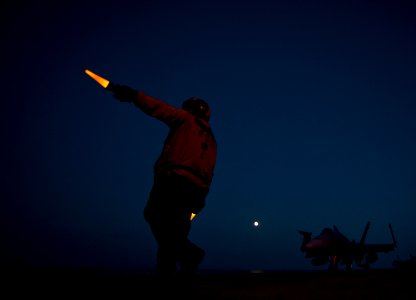 Flickr - Official U.S. Navy Imagery - An aircraft director signals to the pilots of an F-A-18C Hornet.