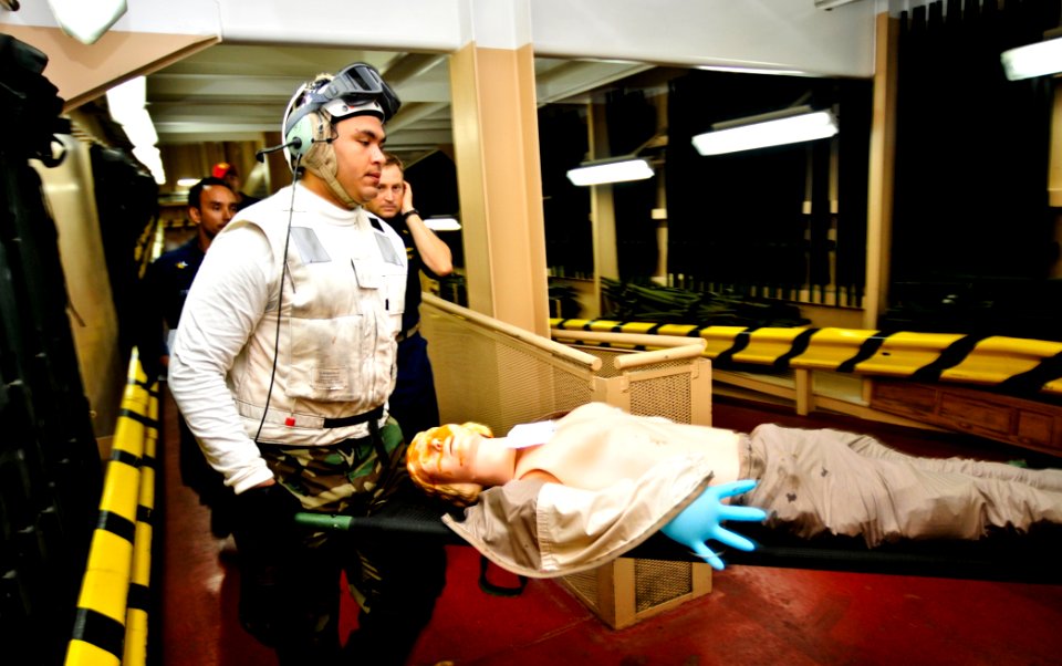 Flickr - Official U.S. Navy Imagery - A Sailor participates in a simulated helicopter crash exercise and transports a patient model down the casualty receiving ramp.