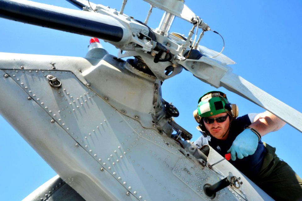 Flickr - Official U.S. Navy Imagery - A Sailor performs maintenance on a helicopter.
