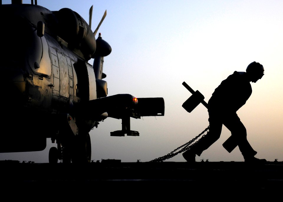 Flickr - Official U.S. Navy Imagery - A Sailor removes the chocks and chains from a helicopter.