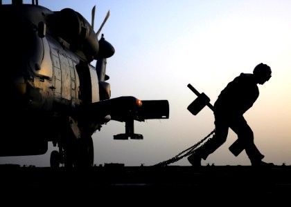 Flickr - Official U.S. Navy Imagery - A Sailor removes the chocks and chains from a helicopter.