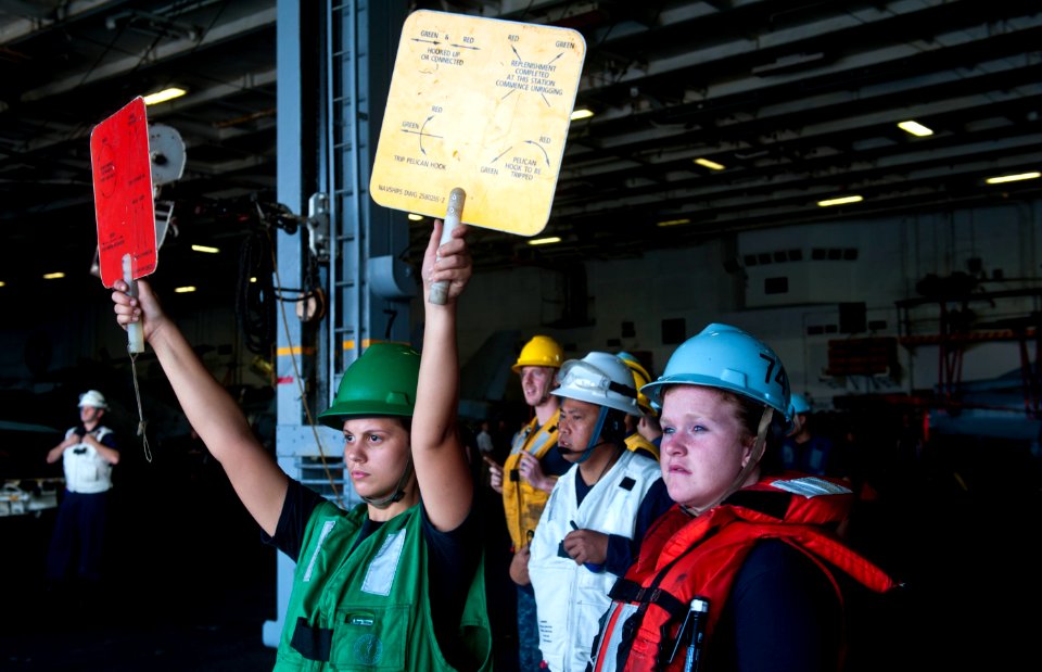Flickr - Official U.S. Navy Imagery - A sailor signals during a replenishment-at-sea.