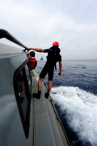 Flickr - Official U.S. Navy Imagery - A Sailor searches the waters in a simulated man overboard exercise during small boat operations.