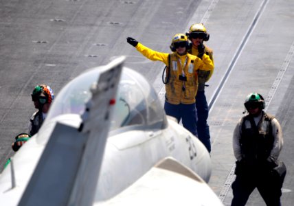 Flickr - Official U.S. Navy Imagery - A Sailor signals to a jet to move into position.