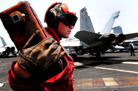 Flickr - Official U.S. Navy Imagery - A Sailor stands by to receive orders to chock an aircraft.