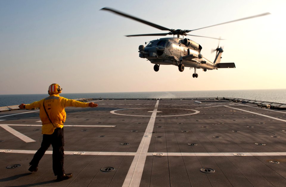 Flickr - Official U.S. Navy Imagery - A Sailor signals for an MH-60R Sea Hawk helicopter.
